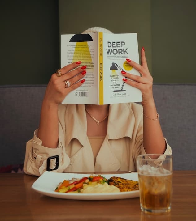 Person reading book in deep work mode