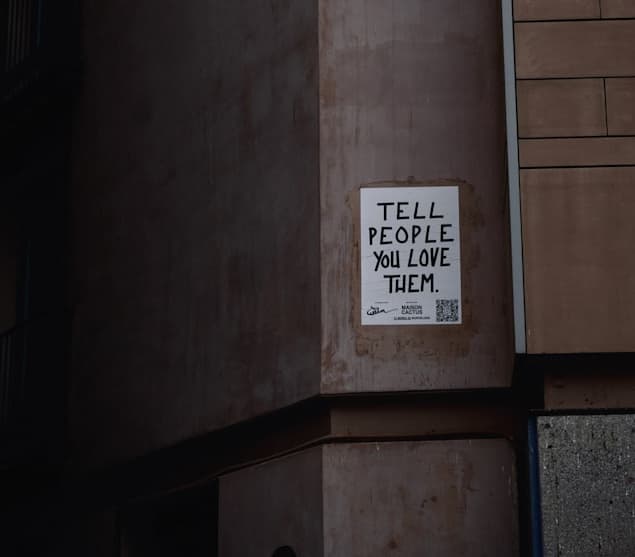Tell people you love them sign on wall