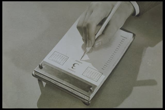 Vintage calendar with notes being jotted down