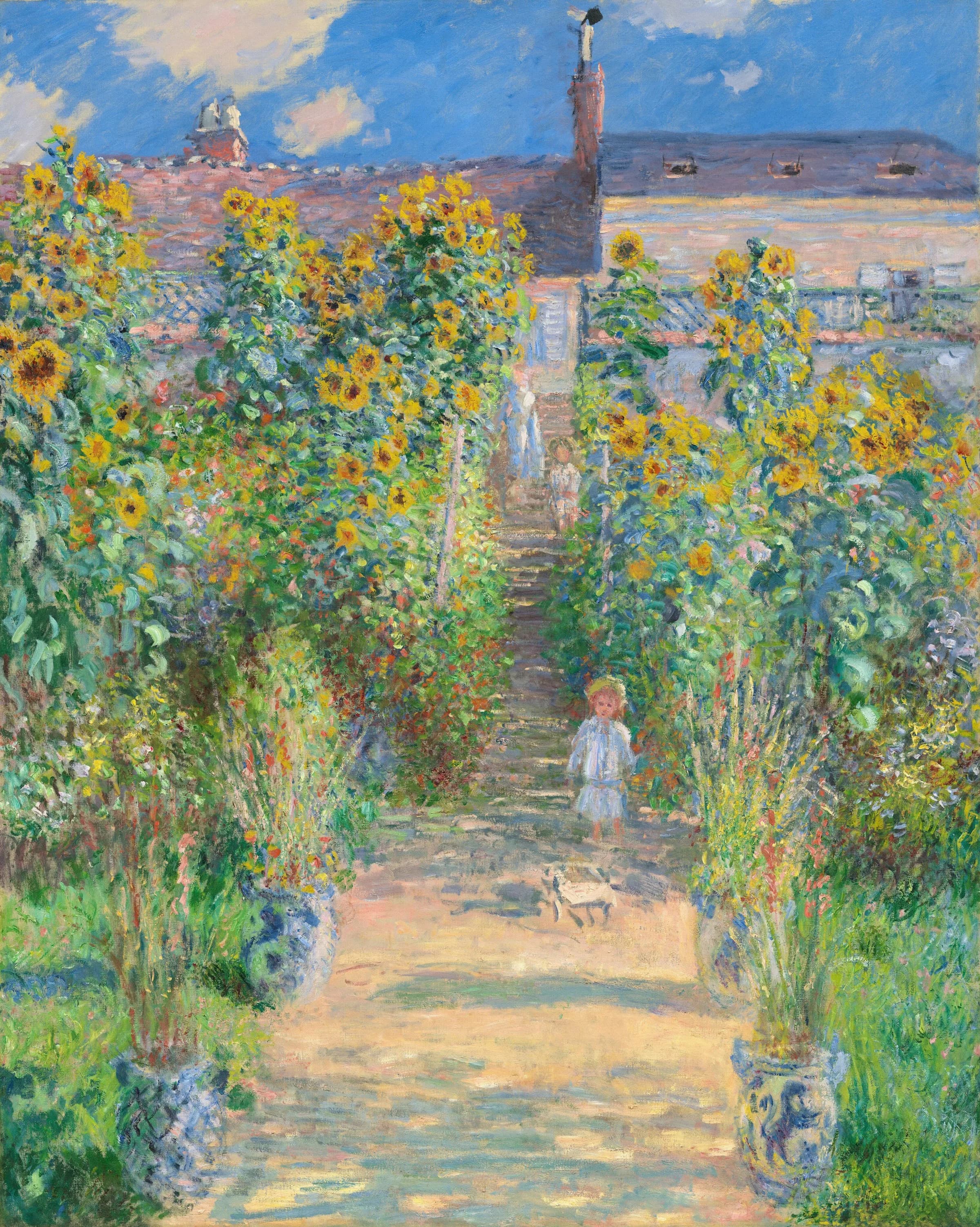 Child walking on road surrounded by sunflowers